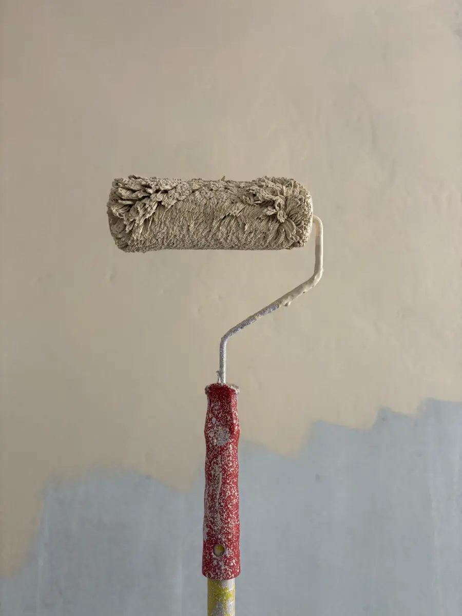 Paint roller loaded with a warm neutral coat
