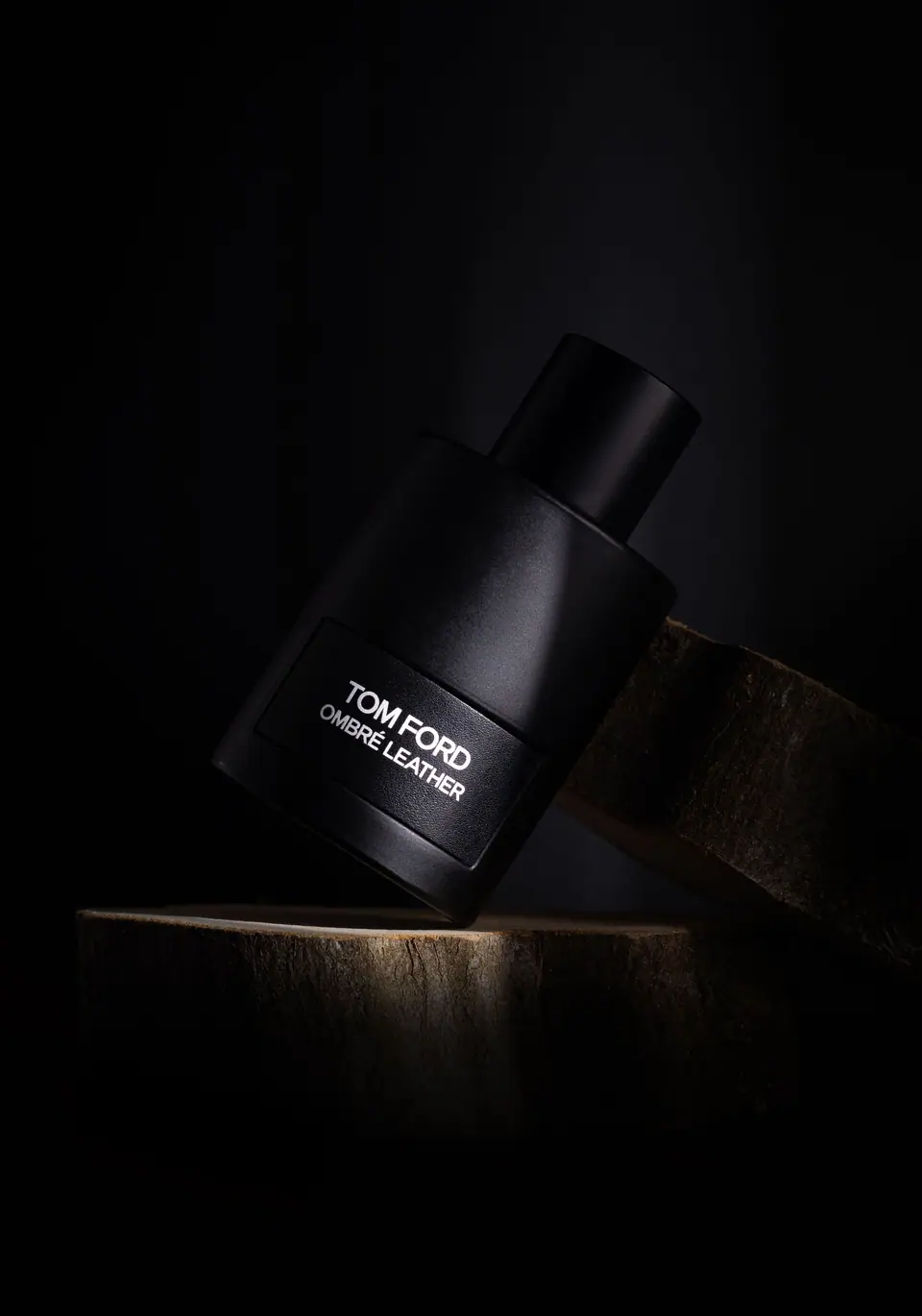 Black perfume bottle in low-key light