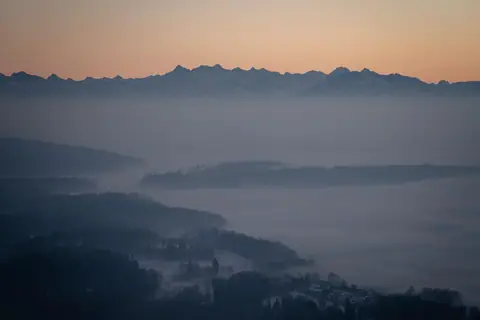 Layered misty mountains at sunrise